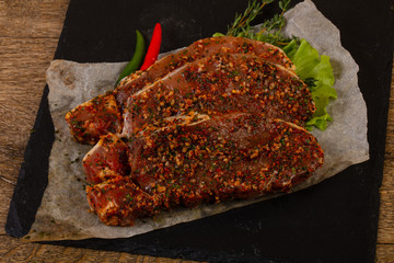 Raw marinated pork steak