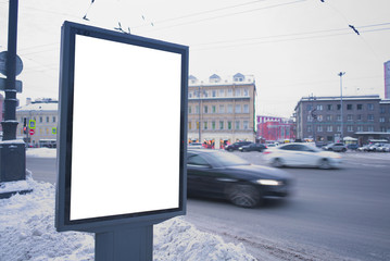 City billboard near the road, gray in winter. vertical ad outdoor