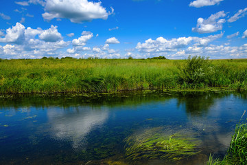 Obraz na płótnie Canvas landscape with river and blue sky