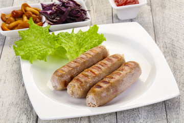 Grilled sausages served mushrooms and cabbage