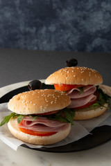 Hamburger with ham. Two burgers, hoemmade food. healthy sandwich with fresh vegetables.