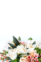 Beautiful bouquet of white tulips with green leaves and other decorative flowers close up.