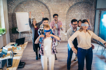 Business people making team training exercise during team building seminar, play a game of trust