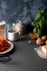 Making dough for carrot cake template with copy space. Cooking pie, muffins or tart, on kitchen table - eggs, flour, butter, orange, citrus, oil, sugar. Food, cake, pie recipe ingredients.
