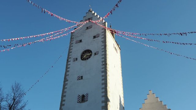 Pfullendorf, Germany. The old tower Oberes part of the ancient medieval fortifications of the city. Small fabric flags waving during the carnival