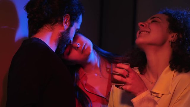 polygamy, threesome,polyamory.Flirting among three people in night club