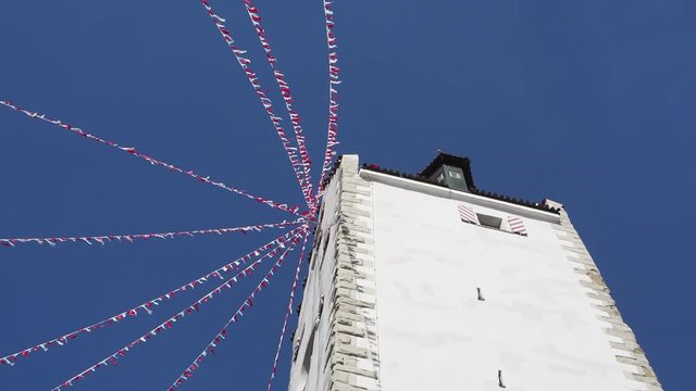 Pfullendorf, Germany. The old tower Oberes part of the ancient medieval fortifications of the city. Small fabric flags waving during the carnival