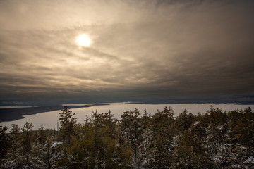 Fototapeta na wymiar Sunset over a frozen Mooselookmeguntic Lake in Rangeley, Maine.