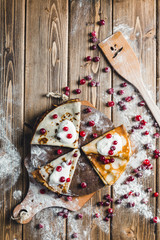 pancakes with cranberries and sour cream on a wooden Board in flour