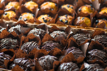 chocolate and berry cupcakes in a basket on the bakery window