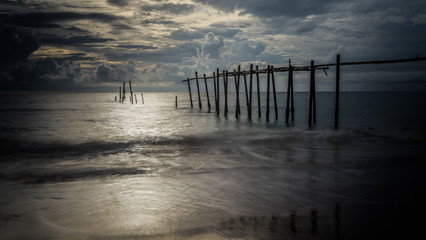 Fototapeta premium Beautiful sunset with old wooden bridge at Khao Pilai in Phang- Nga Province, Thailand