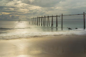 Fototapeta premium Beautiful sunset with old wooden bridge at Khao Pilai in Phang- Nga Province, Thailand