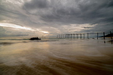 Beautiful sunset with old wooden bridge at Khao Pilai in Phang- Nga Province, Thailand