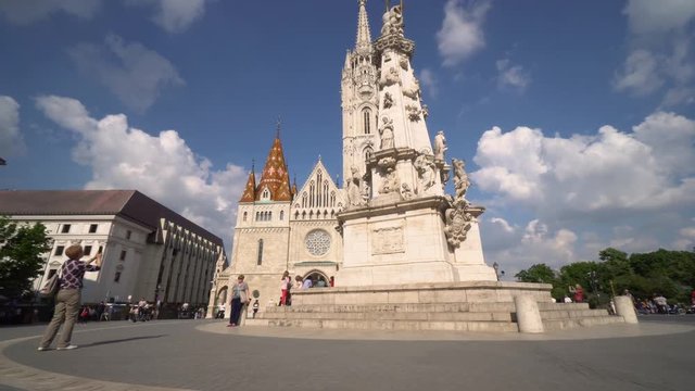 Matthias Church Saint Trinity Monument Buda Castle Sunny Budapest Hungary Tourists Around Main Entrance Rosetted Glass Window Camera Circling