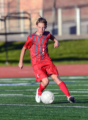 High School boy athlete making amazing plays during a soccer game © Joe