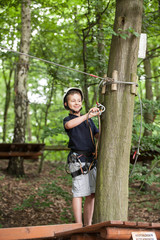 Young teenage boy in a rope park