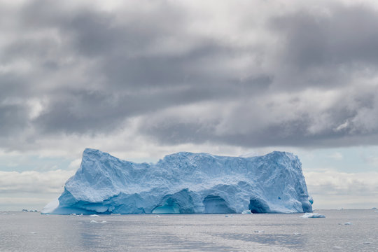 Iceberg under darkening sky
