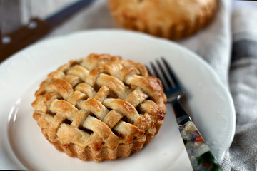 Traditional rustic homemade american  pie  with lattice on white plate with fork