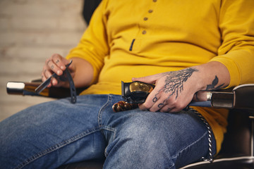 Fototapeta premium Stylish barber man with hairdressing tools in his hands prepare for work