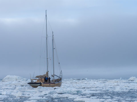 Yacht in the middle of arctic ice floes
