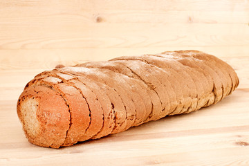 Loaf of sliced bread on a wooden table