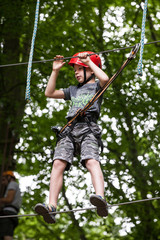 Young teenage boy in a rope park