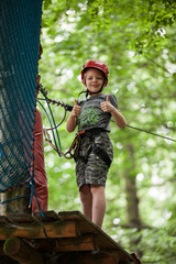 Young teenage boy in a rope park