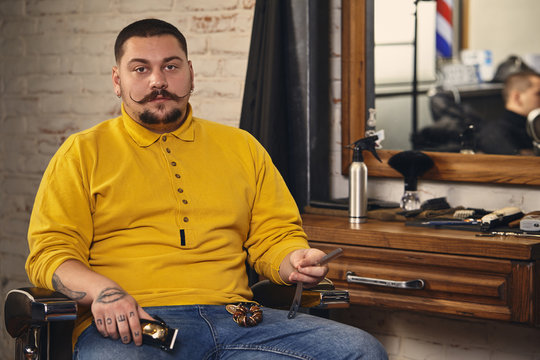 Stylish barber man with hairdressing tools in his hands prepare for work