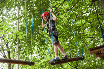 Young teenage boy in a rope park