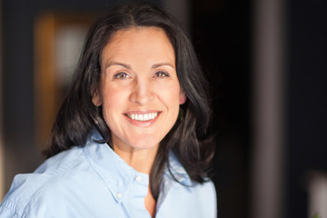 Mature Spanish woman Smiling At The Camera. At The home. She relaxing at home