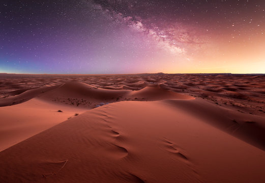 Amazing milky way over the dunes Erg Chebbi in the Sahara desert near Merzouga, Morocco , Africa. Beautiful sand landscape with stunning sky full of stars and night under a starry sky. After sunset