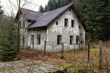 Fototapeta na wymiar Devastated deserted family house with open windows