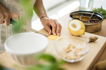Obraz na płótnie Canvas Woman preparing healthy food in her kitchen