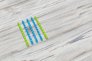 A set of colored candles for a cake on a wooden background. Decoration for the party. design concept. Bright birthday background . birthdays candles.