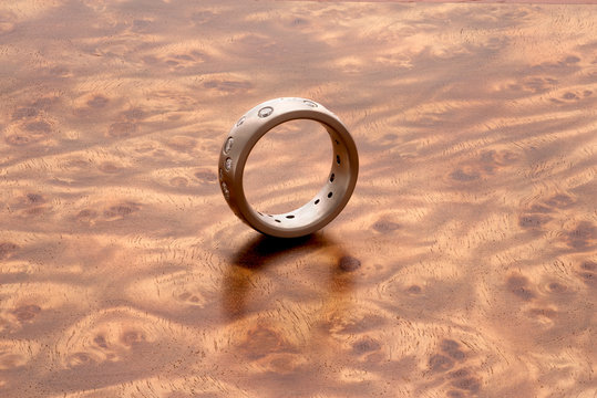Silver ring on Mandora wood grain