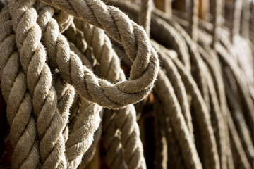 Fototapeta na wymiar Hanging rope close up on an old ship