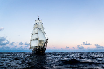 Fototapeta na wymiar German brig roald amundsen sailing on the atlantic at sunset