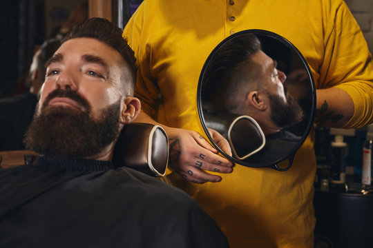 Client With Big Black Beard During Beard Shaving In Barber Shop