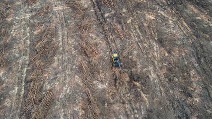 Forestry Forwarder is cleaning up a huge harvested forest area - aerial view 