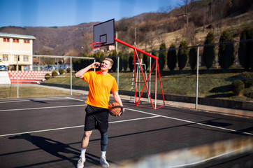 Young basketball player using phone