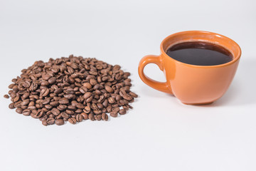 coffee beans and a cup of coffee on a white background