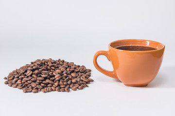 coffee beans and a cup of coffee on a white background