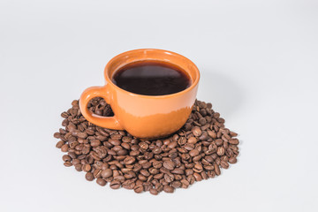 coffee beans and a cup of coffee on a white background