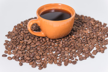 coffee beans and a cup of coffee on a white background