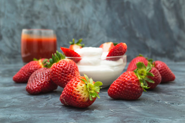 Fresh strawberries with whipped cream on dark background