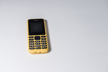 yellow mobile phone with buttons
