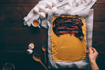 Top view of female's hand spreading currant jam