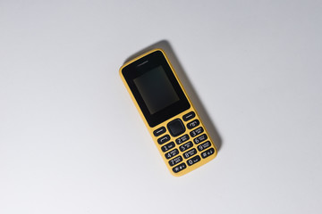 yellow mobile phone with buttons