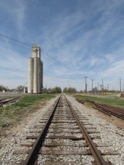 Train tracks past a mill