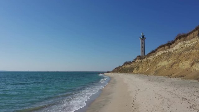 Lighthouse, beautiful beach and  turquoise sea